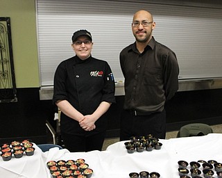 Neighbors | Abby Slanker.Brian Jones, general manager of Whitefire Grill, and Ashton McKendrick, Whitefire pastry chef, offered a taste of avocado mousse and pistachio cheesecake at the Canfield Choral Boosters ‘Blast From The Past’ Dinner Theater on Jan. 28.
