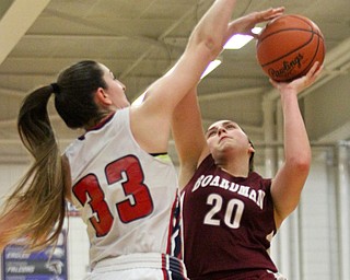 William D Lewis The Vindictor Boardman's Lauren Gabriele(20) shoots past Fitch's Sabria Hunter(33).