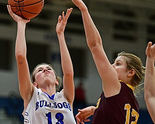 POLAND, OHIO - FEBRUARY 23, 2017: Maggie Sebest #13 of Poland puts up a shot over the arm of Danielle Norquest #12 of Southeast during the first half of their game Thursday night at Poland High School. Southeast won 72-71. DAVID DERMER | THE VINDICATOR