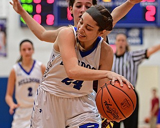 POLAND, OHIO - FEBRUARY 23, 2017: Alea Nicholudis #24 of Poland looks to pass the ball while being pressured from behind by Leann James #4 of Southeast during the first half of their game Thursday night at Poland High School. Southeast won 72-71. DAVID DERMER | THE VINDICATOR