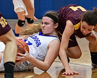 POLAND, OHIO - FEBRUARY 23, 2017: Emily Melneck #42 of Poland looks to pass the ball from the floor after protecting it from Leann James #4 of Southeast during the first half of their game Thursday night at Poland High School. Southeast won 72-71. DAVID DERMER | THE VINDICATOR