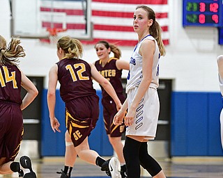 POLAND, OHIO - FEBRUARY 23, 2017: Maggie Sebest #13 of Poland looks at the bench in disbelief while Shelby Morehead #14, Danielle Norquest #12 and Riley Norquest #15 of Southeast celebrate their win after the final buzzer of their game Thursday night at Poland High School. Southeast won 72-71. DAVID DERMER | THE VINDICATOR..Bella Gajdos #23 of Poland pictured.