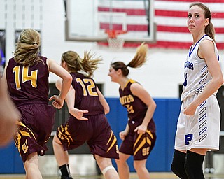 POLAND, OHIO - FEBRUARY 23, 2017: Maggie Sebest #13 of Poland looks at the scoreboard in disbelief while Shelby Morehead #14, Danielle Norquest #12 and Riley Norquest #15 of Southeast celebrate their win after the final buzzer of their game Thursday night at Poland High School. Southeast won 72-71. DAVID DERMER | THE VINDICATOR