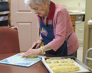 Neighbors | Alexis Bartolomucci.Mary Nicolli cut her biscotti she made before placing them back in the oven to finish cooking.