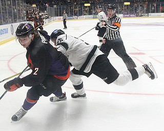Phantoms forward Austin Pooley(12)(right) and Force defenseman Philip Alftberg(32) race towards a loose puck during the 2nd period as the Fargo Force take on the Youngstown Phantoms, Friday, Feb. 24, 2017 at the Covelli Centre in Youngstown. The Phantoms won 2-1 in OT...(Nikos Frazier | The Vindicator)..