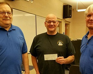 SPECIAL TO THE VINDICATOR
Berlin Ellsworth Ruritan Club recently donated $3,500 to Western Reserve Music Boosters to purchase seven new band uniforms. Dwain VanAuker, left, secretary of the club, presented the check to Robert Bacha, band director, with Lee Fowler, Ruritan board member.
