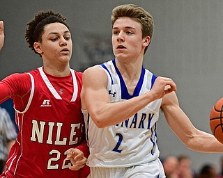 POLAND, OHIO - FEBRUARY 24, 2017: Mike Diaz #2 of Poland looks to pass the ball while being pressured by Corbin Foy #22 of Niles during the second half of their game Friday night at Poland High School. DAVID DERMER | THE VINDICATOR