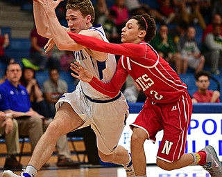 POLAND, OHIO - FEBRUARY 24, 2017: Konnor Morse #14 of Poland drives to the basket while being pressured by Corbin Foy #22 of Niles during the second half of their game Friday night at Poland High School. DAVID DERMER | THE VINDICATOR