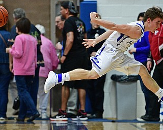 POLAND, OHIO - FEBRUARY 24, 2017: Mike Diaz #2 of Poland flies through the air after preventing the ball from going out of bound during the second half of their game Friday night at Poland High School. DAVID DERMER | THE VINDICATOR