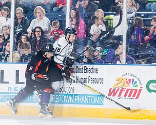 Scott R. Galvin | The Vindicator .Youngstown Phantoms defenseman Andrew Petrillo (5) checks Fargo Force defenseman Clayton Phillips (18) into the board during the second period at the Covelli Centre on February 25, 2017.