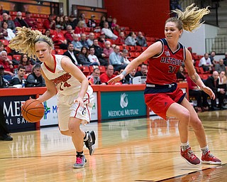 MICHAEL G TAYLOR | THE VINDICATOR- 02-25-17  -Women's  Basketball-  2nd qtr., YSU's #14 Melinda Trimme drives by Detroit Mercy's #21 Gracie Roberts. Detroit Mercy Titans vs YSU Penguins at YSU, Beeghly Center in Youngstown, OH