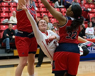 MICHAEL G TAYLOR | THE VINDICATOR- 02-25-17  -Women's  Basketball-  3rd qtr., YSU's #2 Alison Smolinski drives against Detroit Mercy's #11 Rosanna Reynolds and Detroit Mercy's #32 Kelsey Mitchell. Detroit Mercy Titans vs YSU Penguins at YSU, Beeghly Center in Youngstown, OH