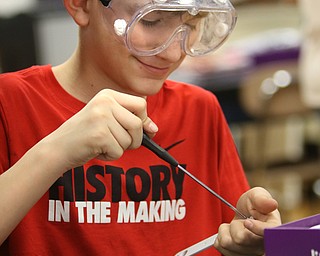        ROBERT K. YOSAY  | THE VINDICATOR..Noah Rouhan   puts together a game piece ..a grant from the Poland schools foundation, a middle school program has some new materials for STEAM -- science, technology, engineering, arts, mathetmatics ÐÐ programs.. .-30-