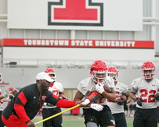 William D. Lewis The Vindicator YSU coach Nic McKissic-Luke works with London Pearson during 2-27-17 spring practice.