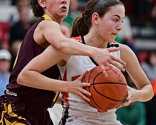 AUSTINTOWN, OHIO - FEBRUARY 27, 2017:  MacKenzie Maze #4 of Howland is pressured by Leann James #4 of Southeast during the first half of their game Monday night at Austintown Fitch High School. DAVID DERMER | THE VINDICATOR