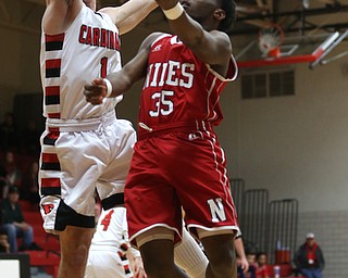 Niles senior guard Ty'rese Williams(35) goes up for a layup as Canfield senior guard Jake Cummings(1) tries to block his shot during the 1st quarter as Niles McKinley takes on Canfield, Tuesday, Feb. 28, 2017 at Canfield High School. Canfield won 70-42...(Nikos Frazier | The Vindicator)..