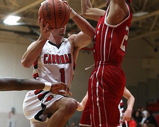 Canfield senior guard Jake Cummings(1) goes up for a layup against Niles senior forward SaQwaan McGuire(23) during the 1st quarter as Niles McKinley takes on Canfield, Tuesday, Feb. 28, 2017 at Canfield High School. Canfield won 70-42...(Nikos Frazier | The Vindicator)..