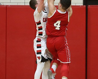 Niles sophomore guard Cyler Kane-Johnson(4) goes up for two under the net as Canfield senior guard Brandon McFall(4) tries to block his shot during the 3rd quarter as Niles McKinley takes on Canfield, Tuesday, Feb. 28, 2017 at Canfield High School. Canfield won 70-42...(Nikos Frazier | The Vindicator)..
