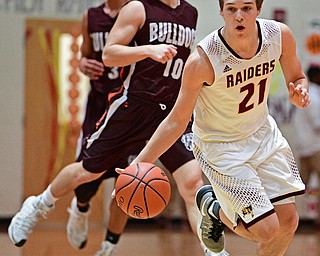 CANFIELD, OHIO - FEBRUARY 28, 2017: Brandon Youngs #21 of South Range dribbles up court away from Parker Sherry #10 and Dominic Posey #3 of East Palestine during the first half of their game Tuesday night at South Range High School. DAVID DERMER | THE VINDICATOR
