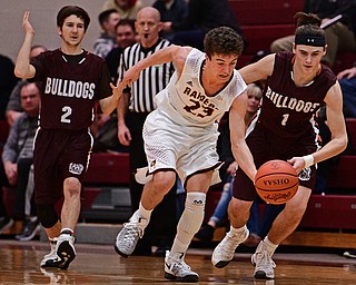 CANFIELD, OHIO - FEBRUARY 28, 2017: Jaxon Anderson #23 of South Range dribbles away from Branden Kemp #1 of East Palestine after taking the ball away from Tom Dumbald #2 during the second half of their game Tuesday night at South Range High School. DAVID DERMER | THE VINDICATOR