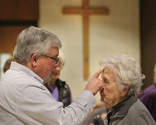 William D. Lewis The Vindicator Western Reserve United Methodist Church pastor Rev Russ Adams distributes ashes to parishioer Lucille Bartlemay of Canfield during an Ash Wednesday service at the Canfield Church.