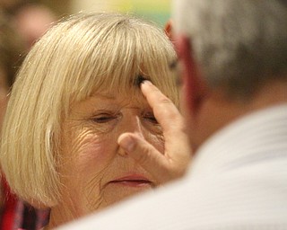 William D. Lewis The Vindicator Western Reserve United Methodist Church pastor Rev Russ Adams distributes ashes to parishioner Caroline Arnasberger of Canfield during an Ash Wednesday service at the Canfield Church.