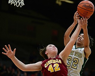 STRUTHERS, OHIO - MARCH 1, 2017: Concetta Rinaldi #42 of Mooney knocks the ball free from the grasp of Simone Comer #32 of Ursuline during the second half of their tournament game Wednesday night at Struthers High School. DAVID DERMER | THE VINDICATOR