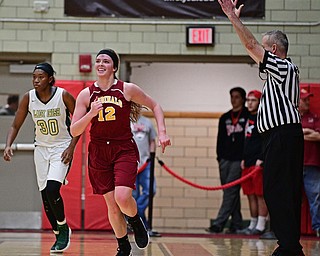STRUTHERS, OHIO - MARCH 1, 2017: Taylor Martin #12 of Mooney smiles after draining a three while being pressured by Anyah Curd #30 of Ursuline during the second half of their tournament game Wednesday night at Struthers High School. DAVID DERMER | THE VINDICATOR