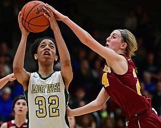STRUTHERS, OHIO - MARCH 1, 2017: Simone Comer #32 of Ursuline is fouled while going to the basket by Kelly Williams #24 of Mooney during the second half of their tournament game Wednesday night at Struthers High School. DAVID DERMER | THE VINDICATOR