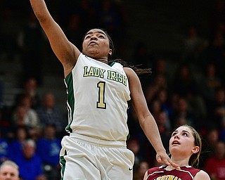 STRUTHERS, OHIO - MARCH 1, 2017: Dayshanette Harris #1 of Ursuline goes to the basket for the lay up while being trailed by Camden Hergenrother #14 of Mooney during the second half of their tournament game Wednesday night at Struthers High School. DAVID DERMER | THE VINDICATOR