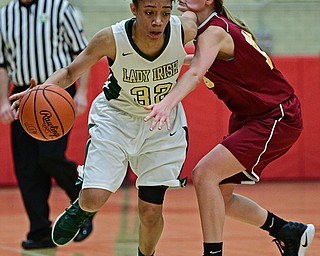 STRUTHERS, OHIO - MARCH 1, 2017: Simone Comer #32 of Ursuline drives on Lauren Frommelt #15 of Mooney during the second half of their tournament game Wednesday night at Struthers High School. DAVID DERMER | THE VINDICATOR