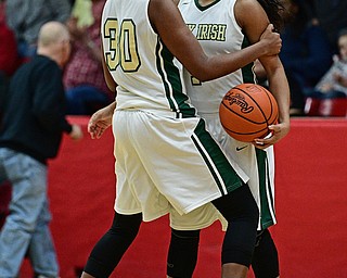 STRUTHERS, OHIO - MARCH 1, 2017: Anyah Curd #30 of Ursuline celebrates with teammate Dayshanette Harris #1 after the final buzzer of their tournament game Wednesday night at Struthers High School. DAVID DERMER | THE VINDICATOR