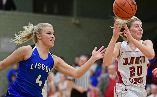 STRUTHERS, OHIO - MARCH 1, 2017: Alexis Cross #20 of Columbiana has the ball knocked free from behind by Hailee Carpenter #4 of Lisbon during the first half of their tournament game, Wednesday night at Struthers High School. DAVID DERMER | THE VINDICATOR
