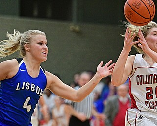 STRUTHERS, OHIO - MARCH 1, 2017: Alexis Cross #20 of Columbiana has the ball knocked free from behind by Hailee Carpenter #4 of Lisbon during the first half of their tournament game, Wednesday night at Struthers High School. DAVID DERMER | THE VINDICATOR