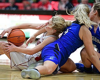 STRUTHERS, OHIO - MARCH 1, 2017: Alexis Cross #20 of Columbiana wrested for the ball with Hailee Carpenter #4 and Chloe Smith #5 of Lisbon during the first half of their tournament game, Wednesday night at Struthers High School. DAVID DERMER | THE VINDICATOR