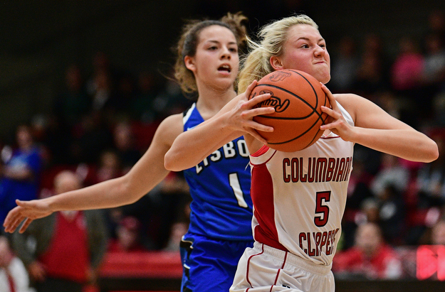 STRUTHERS, OHIO - MARCH 1, 2017: Tessa Liggett #5 of Columbiana goes to the basket while being chased by Izzy Perez #1 of Lisbon during the first half of their tournament game, Wednesday night at Struthers High School. DAVID DERMER | THE VINDICATOR