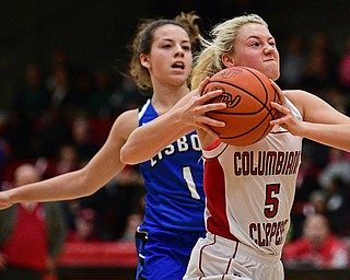 STRUTHERS, OHIO - MARCH 1, 2017: Tessa Liggett #5 of Columbiana goes to the basket while being chased by Izzy Perez #1 of Lisbon during the first half of their tournament game, Wednesday night at Struthers High School. DAVID DERMER | THE VINDICATOR