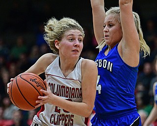STRUTHERS, OHIO - MARCH 1, 2017: Alexis Cross #20 of Columbiana drives on Hailee Carpenter #4 of Lisbon during the first half of their tournament game, Wednesday night at Struthers High School. DAVID DERMER | THE VINDICATOR