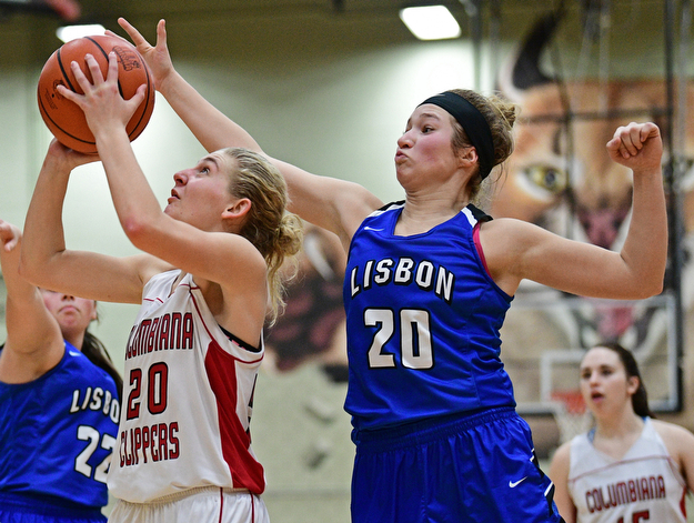 STRUTHERS, OHIO - MARCH 1, 2017: Alexis Cross #20 of Columbiana goes to the basket before having her shot blocked by Autumn Oehlstrom #20 of Lisbon during the second half of their tournament game, Wednesday night at Struthers High School. DAVID DERMER | THE VINDICATOR