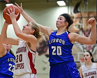 STRUTHERS, OHIO - MARCH 1, 2017: Alexis Cross #20 of Columbiana goes to the basket before having her shot blocked by Autumn Oehlstrom #20 of Lisbon during the second half of their tournament game, Wednesday night at Struthers High School. DAVID DERMER | THE VINDICATOR