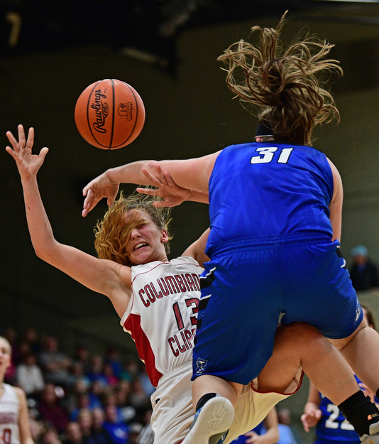 STRUTHERS, OHIO - MARCH 1, 2017: Mariah Rovnak #13 of Columbiana is fouled hard by MacKenzie Mason #31 of Lisbon during the second half of their tournament game, Wednesday night at Struthers High School. DAVID DERMER | THE VINDICATOR