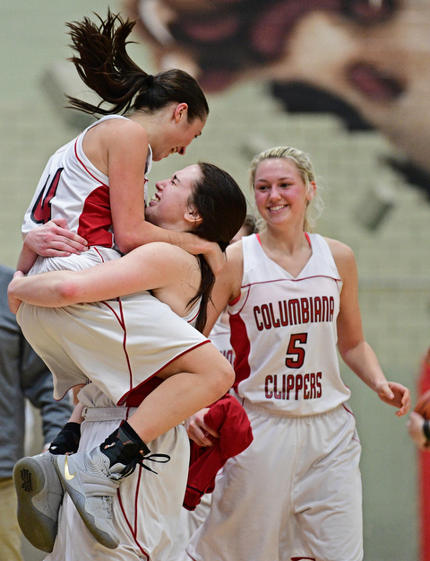 STRUTHERS, OHIO - MARCH 1, 2017: Kayla Muslovski #4 of Columbiana celebrates with teammate Kennedy Fullum #15 after defeating Lisbon in their tournament game, Wednesday night at Struthers High School. DAVID DERMER | THE VINDICATOR