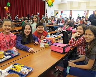 Neighbors | Alexis Bartolomucci.Students sat with new people during the No One Eats Alone day at Austintown Intermediate School on Feb. 10.