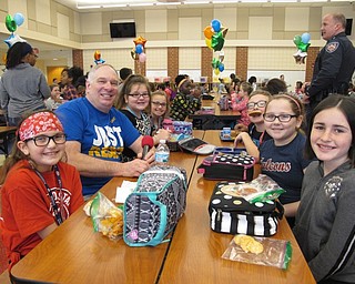 Neighbors | Alexis Bartolomucci.Officer Jeff Toth sat with fourth-grade students on Feb. 10 during the No One Eats Alone day at Austintown Intermediate School.