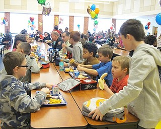 Neighbors | Alexis Bartolomucci.Police officers and teachers sat with Austintown Intermediate School students on Feb. 10 during the No One Eats Alone day.