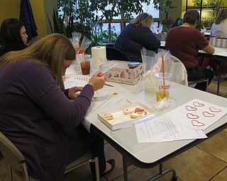 Neighbors | Alexis Bartolomucci.Guests piped royal icing on their cookies to decorate them during the cookie decorating program at Fellows Riverside Gardens on Feb. 11.