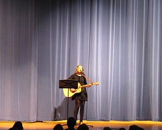 Neighbors | Alexis Bartolomucci.A Poland Seminary High School student played guitar as she sang a song she wrote for the talent show on Feb. 6.