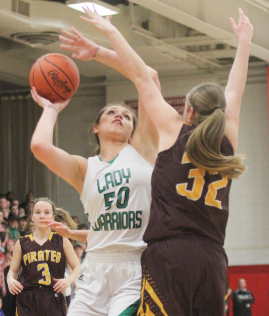 William D. Lewis The Vindicator  Westbranch's Natalie Zuchowski(50) shoots over  South East's Andrea Radcliff(32) go for a loose ball during 3-2-17 action at Fitch.