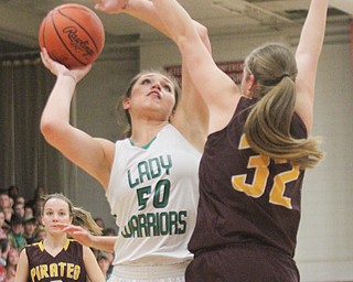 William D. Lewis The Vindicator  Westbranch's Natalie Zuchowski(50) shoots over  South East's Andrea Radcliff(32) go for a loose ball during 3-2-17 action at Fitch.