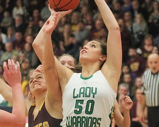 William D. Lewis The Vindicator  Westbranch's Natalie Zuchowski(50)) shoots past South East's Brittany Bolevich(33) during 3-2-17 action at Fitch.